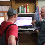 Dr. Ganal im Gespräch mit einem Landwirt vor dessen Computer